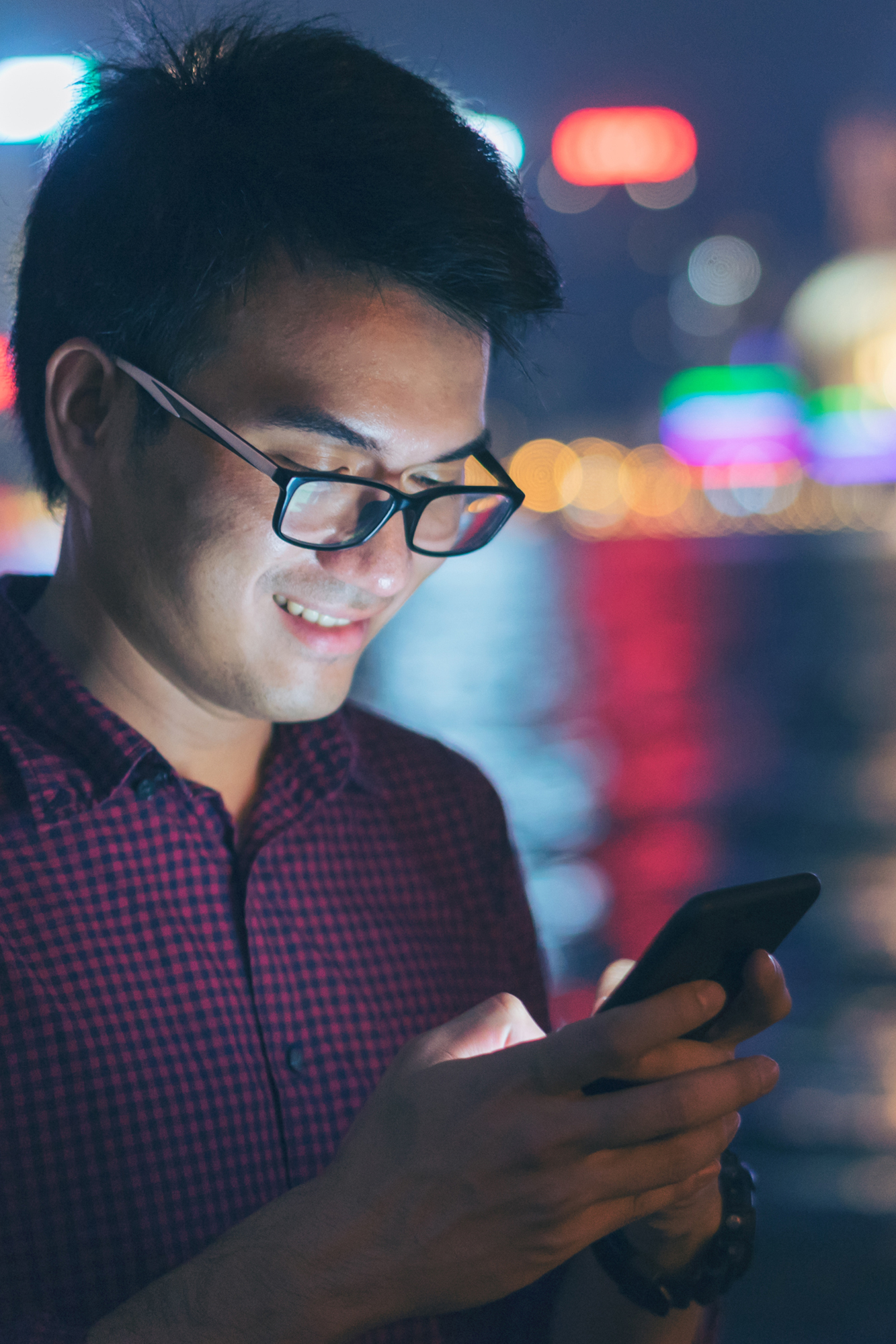 Photograph of a man using his iPhone